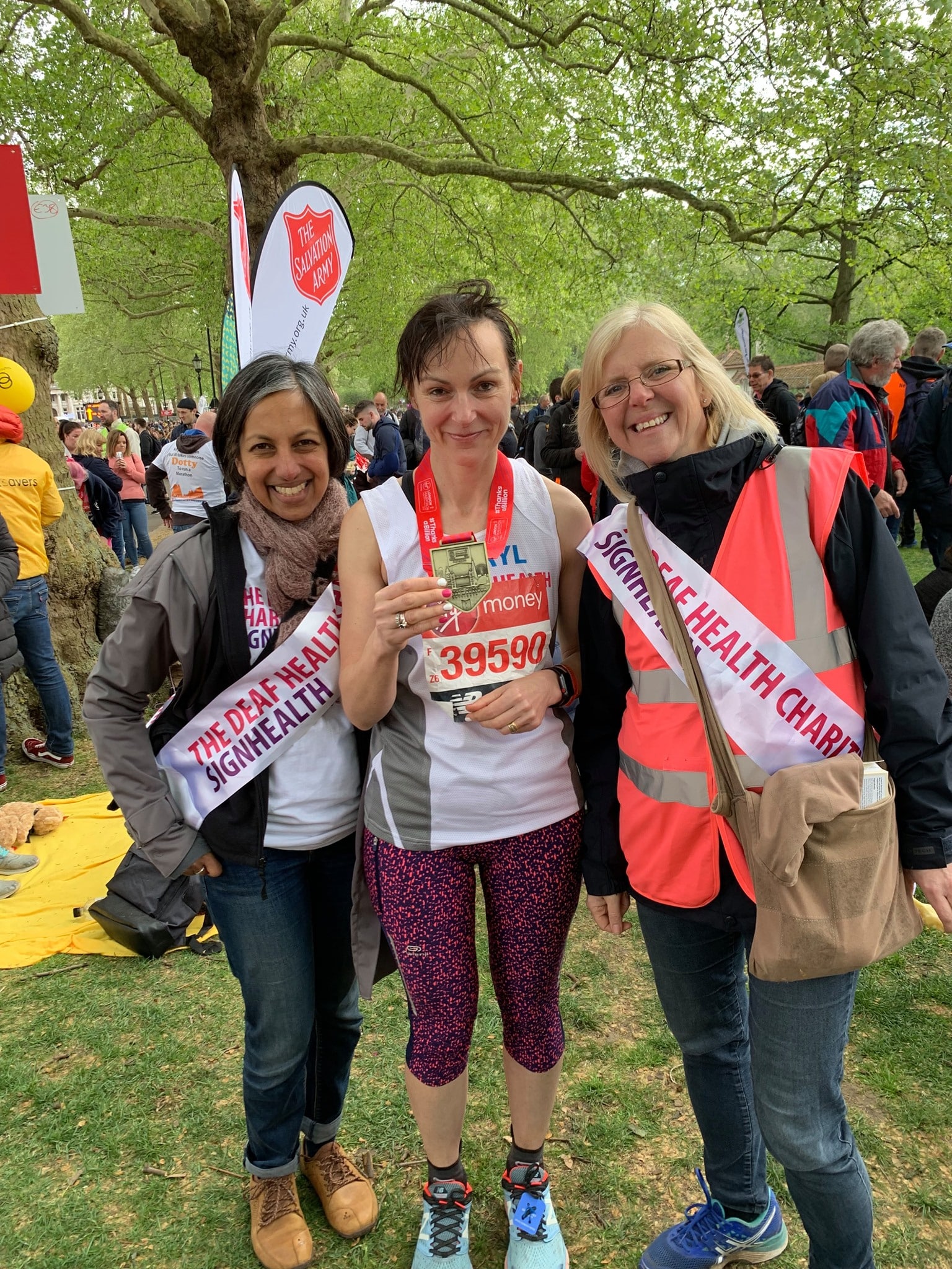 signhealth supporters after a race with medals in a park