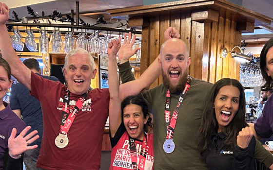 SignHealth London Marathon runners with staff celebrating in 2023