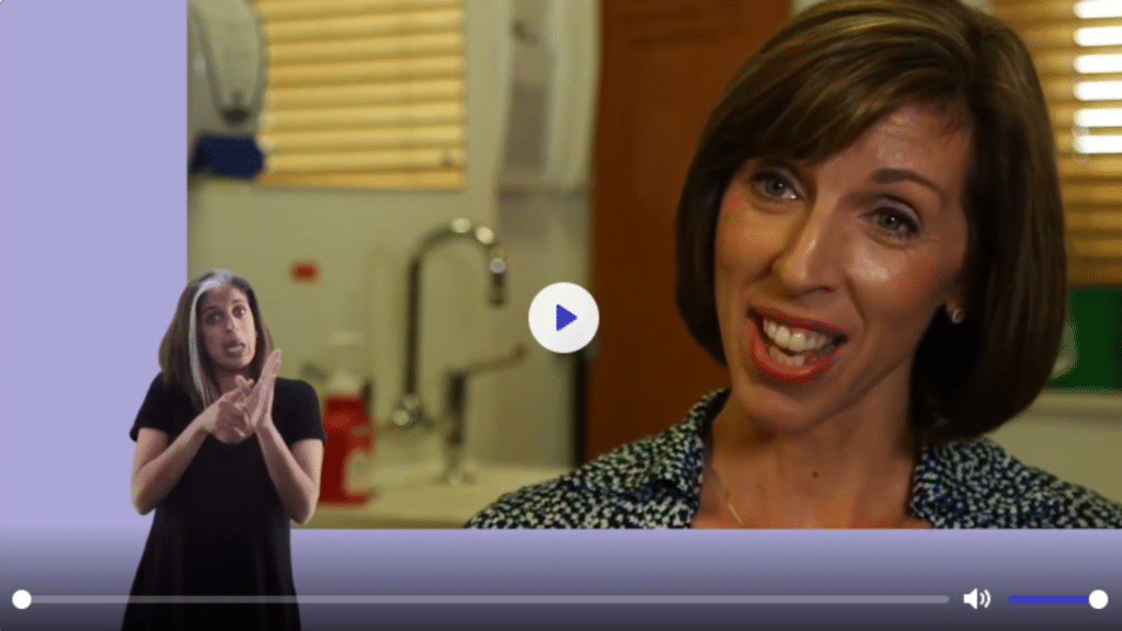 Screen grab of in vision female of colour BSL with video of a female dark haired doctor speaking about menopause. Branding blue colour.