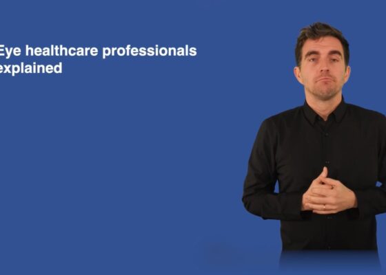 Blue background with the text Eye healthcare professionals explained an a BSL translator man wearing a black shirt