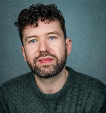 Person with beard and curly hair