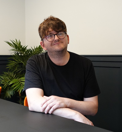 Person wearing black tshirt and glasses