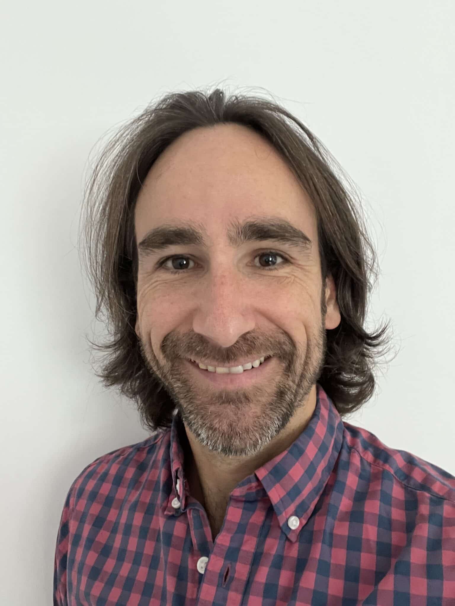 Man smiling with beard and long hair