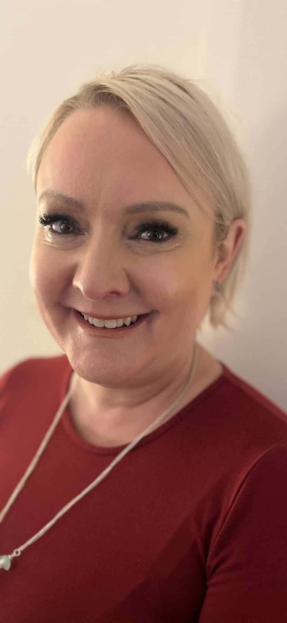 Woman smiling wearing a red shirt