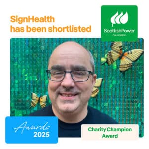White male wearing glasses and dark t shirt, against a green tiled wall and butterflies. Scottish Power Awards logo 2025 charity champion.