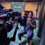 Woman signing to large tv camera